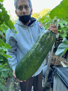 A garden member displays his harvest on October 20, 2021 (Photo credit: Damon Krukowski)